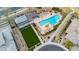 Aerial view of a community pool area, featuring a large pool, lounge chairs, and a covered seating area at 12382 Tudor Arch Dr, Las Vegas, NV 89138
