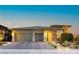 Modern home exterior boasting a three-car garage, stone accents, and landscaped front yard at 12382 Tudor Arch Dr, Las Vegas, NV 89138