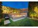 Inviting backyard fire pit with built-in seating and stylish landscaping at 12382 Tudor Arch Dr, Las Vegas, NV 89138