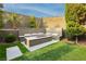 Landscaped backyard featuring an inviting fire pit with seating, perfect for outdoor entertaining and relaxation at 12382 Tudor Arch Dr, Las Vegas, NV 89138