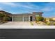 Charming single-story home with a three-car garage, well-maintained landscaping and a driveway at 12382 Tudor Arch Dr, Las Vegas, NV 89138