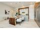 Bright, modern kitchen and dining area with hardwood table and pendant lighting at 12382 Tudor Arch Dr, Las Vegas, NV 89138