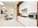 Bright kitchen showcasing stainless steel appliances and white cabinets, with ample counter space at 12382 Tudor Arch Dr, Las Vegas, NV 89138