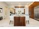 Spacious, eat-in kitchen features wood dining table, stainless steel appliances, and ample storage at 12382 Tudor Arch Dr, Las Vegas, NV 89138