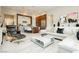 Modern living room features a white sectional sofa, designer chair and contemporary art at 12382 Tudor Arch Dr, Las Vegas, NV 89138
