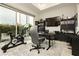 Well-lit home office with exercise equipment and backyard view at 12382 Tudor Arch Dr, Las Vegas, NV 89138