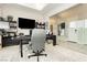 Modern office with exercise equipment, large TV, and glass wall at 12382 Tudor Arch Dr, Las Vegas, NV 89138
