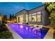 Inviting backyard pool with submerged lounge chairs and manicured landscaping at dusk at 12382 Tudor Arch Dr, Las Vegas, NV 89138