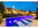Tranquil backyard pool area with desert landscaping and soft lighting at twilight at 12382 Tudor Arch Dr, Las Vegas, NV 89138