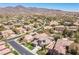 Expansive aerial view of a residential area featuring tile roofs and mountain backdrop at 17 Winding Rd, Henderson, NV 89052