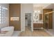 Beautiful bathroom with standalone tub, wood accent wall, and access to the walk-in closet and shower at 17 Winding Rd, Henderson, NV 89052