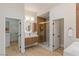 Open bathroom featuring a walk-in shower, double vanity and access to a walk-in closet at 17 Winding Rd, Henderson, NV 89052