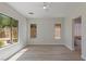 Bright bedroom featuring wood floors, neutral walls, and large windows with views of the outdoor landscape at 17 Winding Rd, Henderson, NV 89052