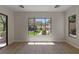 This bedroom has wood floors and a large window with views of the backyard with pool and outdoor grill at 17 Winding Rd, Henderson, NV 89052