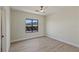 Minimalist bedroom showcasing wood floors and mountain views from a large window at 17 Winding Rd, Henderson, NV 89052