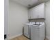 Laundry room with white cabinets and appliances at 17 Winding Rd, Henderson, NV 89052