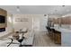 Open concept living room showcasing a modern fireplace, stylish furnishings, and kitchen view at 17 Winding Rd, Henderson, NV 89052