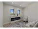 Cozy living room featuring a modern electric fireplace, neutral furniture, and plenty of natural light at 17 Winding Rd, Henderson, NV 89052