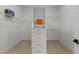 Bright walk-in closet with custom shelving, drawers, and hanging rods, for organized storage at 17 Winding Rd, Henderson, NV 89052