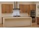 Bright kitchen with stainless appliances, modern island, and wood cabinets at 182 Robledo St, Las Vegas, NV 89138