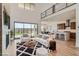 Open concept living room with kitchen access and outdoor views at 182 Robledo St, Las Vegas, NV 89138