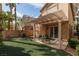 Backyard with artificial turf and a covered patio at 1839 Thunder Mountain Dr, Henderson, NV 89012