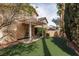 Spacious backyard with artificial turf, covered patio, and privacy landscaping at 1839 Thunder Mountain Dr, Henderson, NV 89012