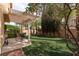 This backyard features a well-manicured lawn and covered patio at 1839 Thunder Mountain Dr, Henderson, NV 89012
