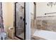 Bathroom features a glass shower, bathtub, and decorative tiling at 1839 Thunder Mountain Dr, Henderson, NV 89012