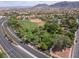 Aerial view of a community park with ballfields, trees, walking path, and lush greenery at 1839 Thunder Mountain Dr, Henderson, NV 89012