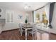 Dining area with a wood table, white chairs, and access to the outdoor patio at 1839 Thunder Mountain Dr, Henderson, NV 89012