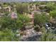 A two-story home with a tile roof, attached garage, surrounded by mature landscaping and desert surroundings at 1839 Thunder Mountain Dr, Henderson, NV 89012