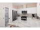 Well-lit kitchen features granite countertops, stainless steel appliances, and ample cabinet space at 1839 Thunder Mountain Dr, Henderson, NV 89012