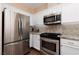 Updated kitchen features stainless steel appliances and ample cabinet space at 1839 Thunder Mountain Dr, Henderson, NV 89012