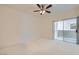 Spacious carpeted bedroom with ceiling fan and sliding glass doors to the balcony at 1881 W Alexander Rd # 1092, North Las Vegas, NV 89032