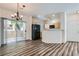 View of kitchen, dining area with chandelier, sliding door to porch, and wood-look flooring at 1881 W Alexander Rd # 1092, North Las Vegas, NV 89032