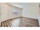 Bright living room featuring wood-look floors, neutral walls, and a front door entrance at 1881 W Alexander Rd # 1092, North Las Vegas, NV 89032
