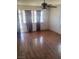 Living room with hardwood floors, a ceiling fan, and large windows providing ample light at 192 W Alma Ave, Overton, NV 89040