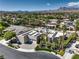 Beautiful aerial view of a home with solar panels, a three-car garage, and lush landscaping in a tranquil neighborhood at 2017 Slow Wind St, Las Vegas, NV 89134