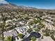 Panoramic aerial shot of a residential area with diverse homes, lush greenery, and distant mountain views at 2017 Slow Wind St, Las Vegas, NV 89134