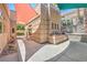 Exterior view of the backyard with an outdoor kitchen area, built-in grill, and colorful sunshades at 2017 Slow Wind St, Las Vegas, NV 89134
