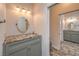 Bathroom with vanity, tile countertop, sink, and decorative lighting at 2017 Slow Wind St, Las Vegas, NV 89134