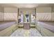 Bedroom with two beds, rug, and windows at 2017 Slow Wind St, Las Vegas, NV 89134