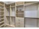 Large walk-in closet with extensive built-in shelves and hanging rods for organized storage at 2017 Slow Wind St, Las Vegas, NV 89134