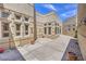 Spacious courtyard featuring a unique architectural design with multiple windows and decorative pots at 2017 Slow Wind St, Las Vegas, NV 89134