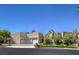 Inviting exterior of home featuring a three-car garage, mature landscaping, and neutral stucco at 2017 Slow Wind St, Las Vegas, NV 89134