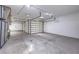 This spacious garage offers ample room for multiple cars and storage, complete with a ceiling fan and ample lighting at 2017 Slow Wind St, Las Vegas, NV 89134