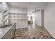 Spacious laundry room with custom cabinets, stainless steel sink, stone floors and ample counter space at 2017 Slow Wind St, Las Vegas, NV 89134