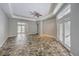 Spacious living room with unique stone tile flooring and double doors to the outside at 2017 Slow Wind St, Las Vegas, NV 89134