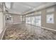 Open-concept living room featuring beautiful tiling, a neutral color palette, and lots of natural light at 2017 Slow Wind St, Las Vegas, NV 89134